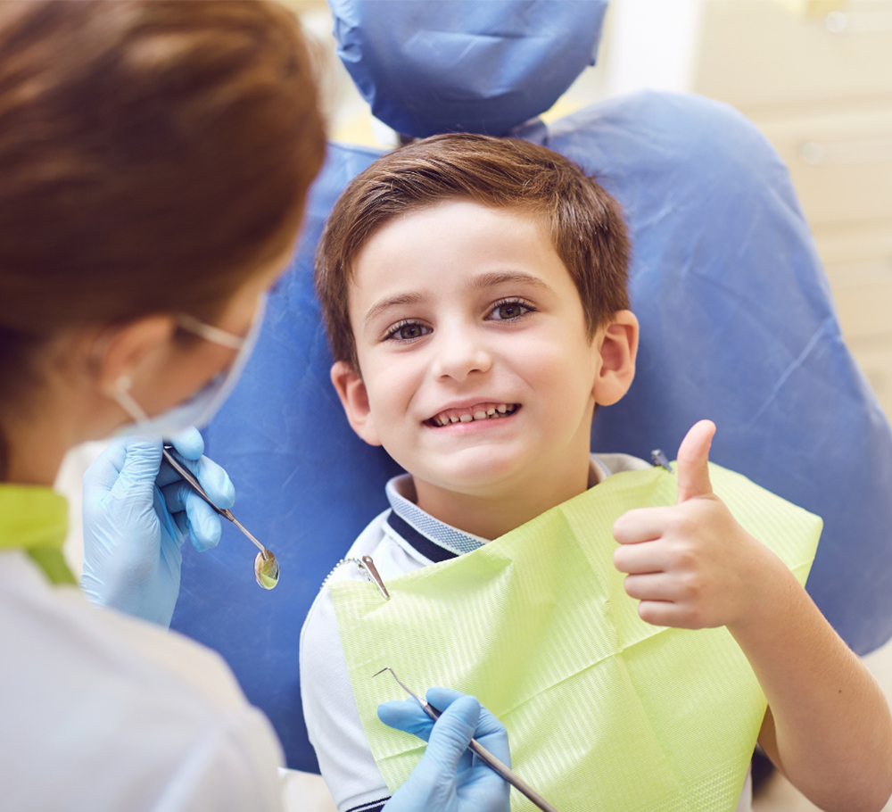 Kids dentist at Greenwood Park Dentistry examining child's teeth